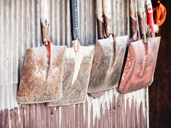 Close-up of clothes drying on wood against wall