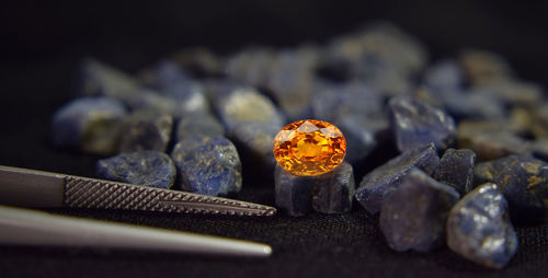 The yellow gemstone has glitter and light shadows on the floor.