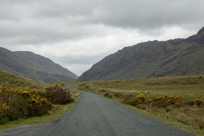 Road amidst mountains against sky