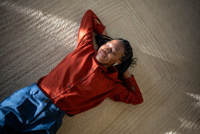 Portrait of young woman sitting on floor at home