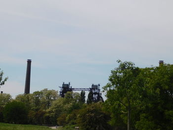 Low angle view of factory against sky