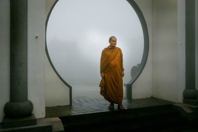 Rear view of man standing against building