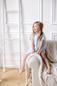 Beautiful young woman sitting at home