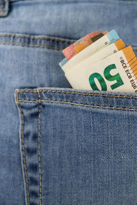Close-up of currencies in pocket