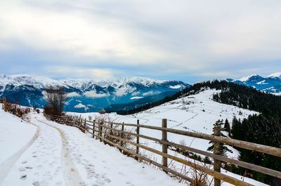 Scenic view of snow covered landscape against sky