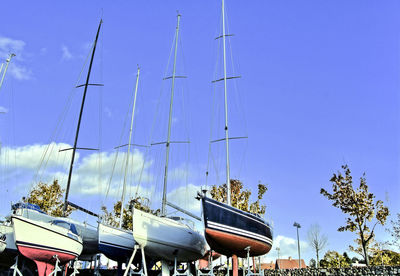 Low angle view of ship moored against clear blue sky