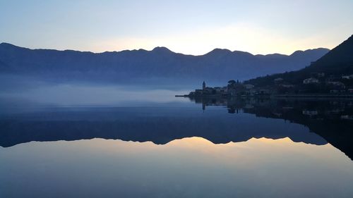 Scenic view of lake against sky during sunset