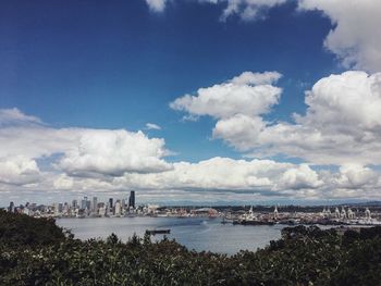 Panoramic view of city against cloudy sky