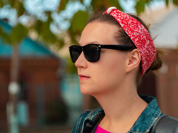 Close-up portrait of woman wearing sunglasses