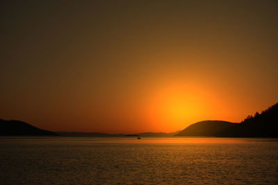 Scenic view of sea against romantic sky at sunset