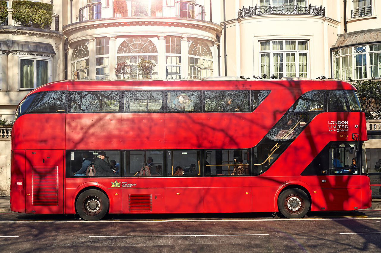 red, architecture, land vehicle, building exterior, mode of transport, built structure, day, transportation, fire engine, car, outdoors, double-decker bus, no people, city