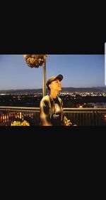 Man in city against clear sky