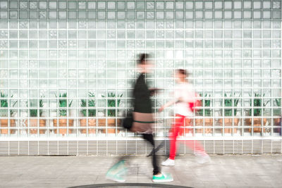 Blurred motion of man and woman running