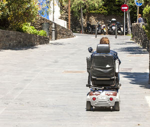 Rear view of two people on footpath