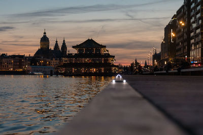 View of illuminated buildings against sky at sunset