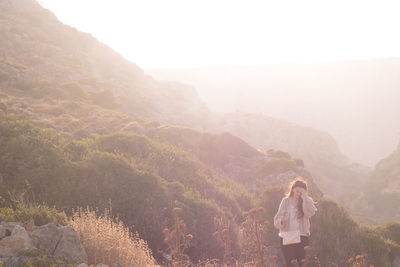 Rear view of man walking on mountain