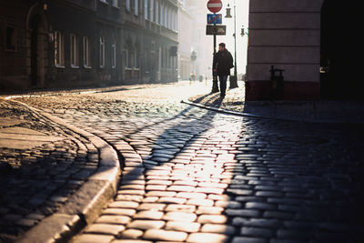 Full length rear view of man walking in city
