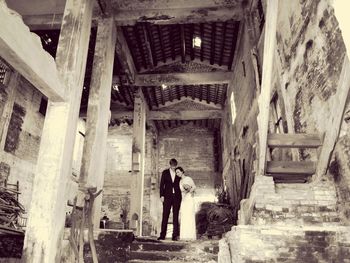 Full length of woman standing in old building