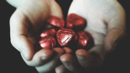 Cropped hand holding chocolates