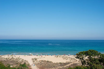 Scenic view of sea against clear blue sky