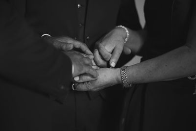 Midsection of couple holding hands