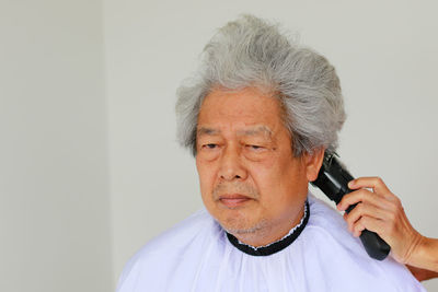 Portrait of man against white background