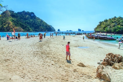 People at beach against sky