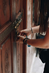 Cropped hand of woman locking a door 