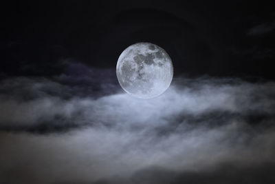 Low angle view of moon against sky at night