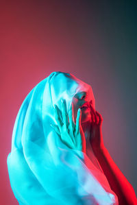 Close-up of woman against gray background