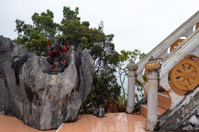 Panoramic shot of sculpture by building against sky