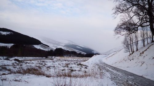 Scenic view of snow covered mountains against sky