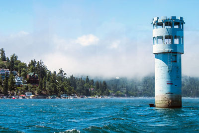 Tower in sea against sky