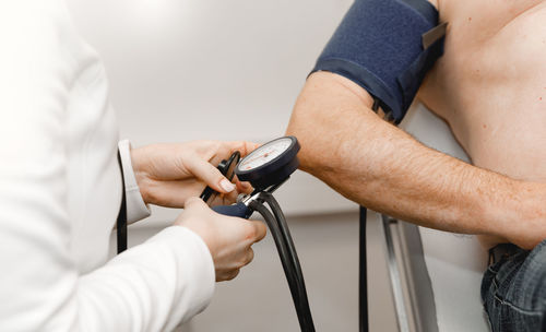 Doctor checking old man's arterial blood pressure. health care. medical concept