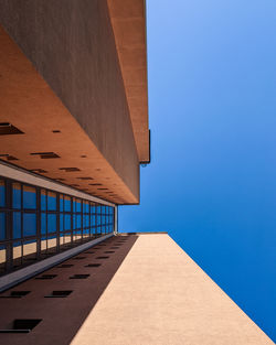 Low angle view of building against clear blue sky