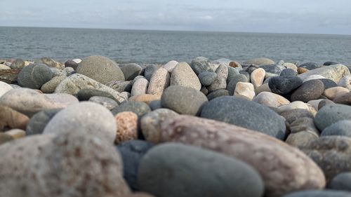 Rocks on beach against sky