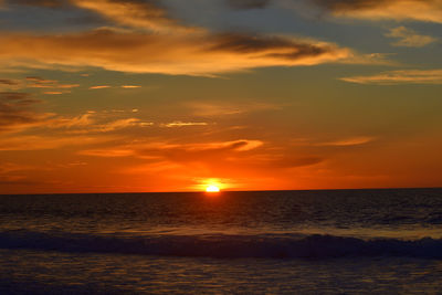 Scenic view of sea against orange sky