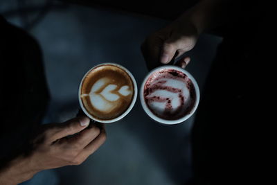 Cropped image of hand holding coffee cup