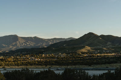 Scenic view of lake and mountains against clear sky