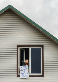 Portrait of woman standing against building