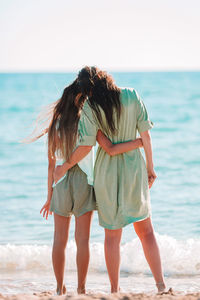 Rear view of women on beach