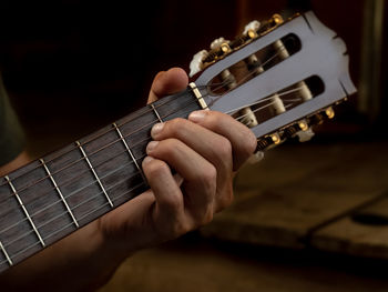 Cropped hand of person playing guitar