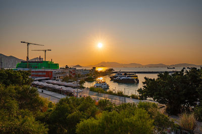 Scenic view of city against sky during sunset