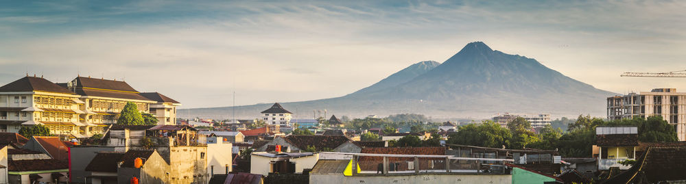 Town by mountains against sky