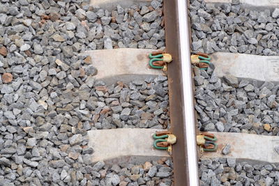 Close-up of railroad track by wall