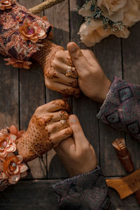 Directly above shot of couple holding hands at table