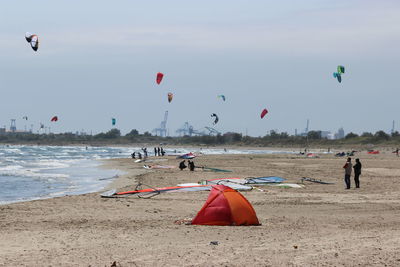 People on beach against sky