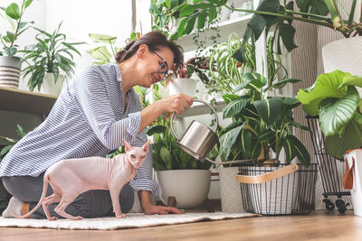 Young woman using mobile phone while sitting at home