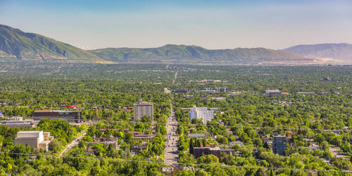 High angle view of field by buildings against sky