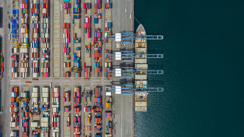 Aerial view of multi colored cargo container by lake